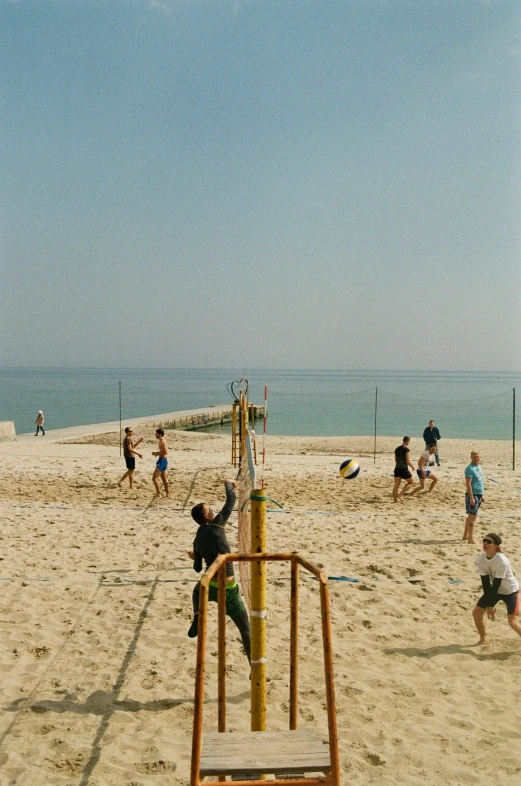 a beach filled with people and a large structure