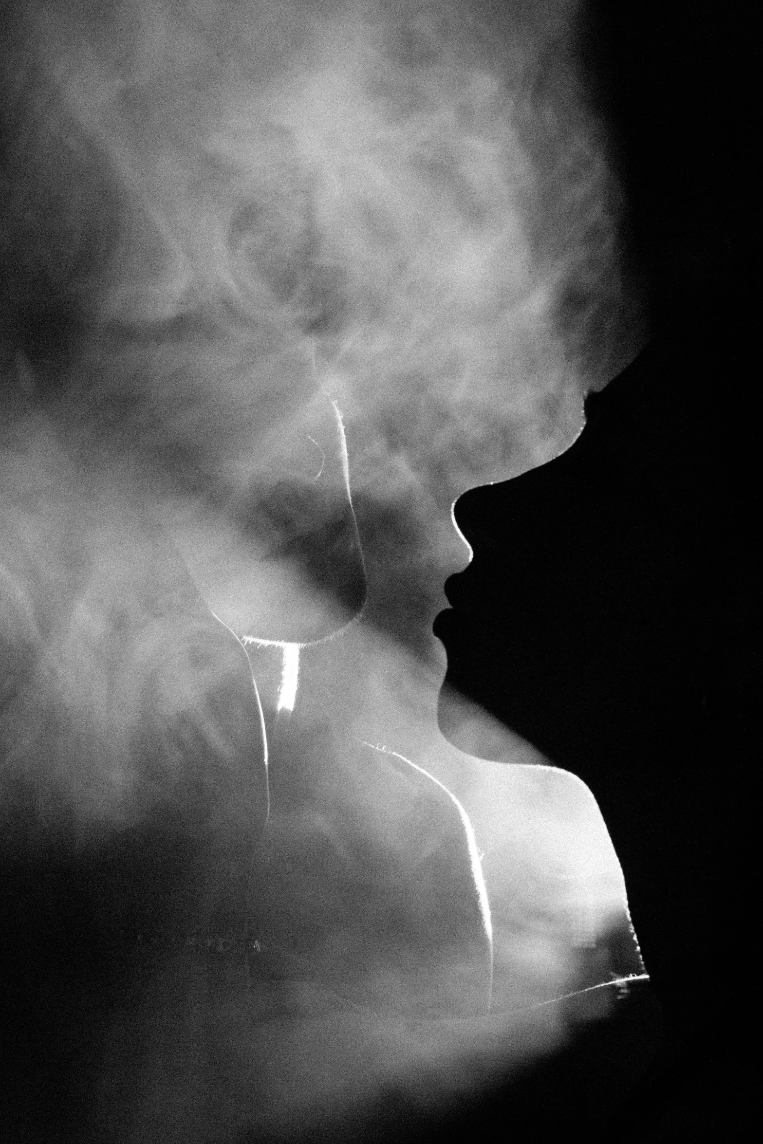 a female wearing a white shirt with smoke in the air