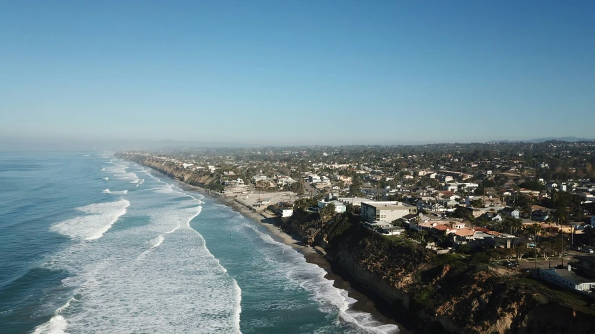 a beach next to a city by the water