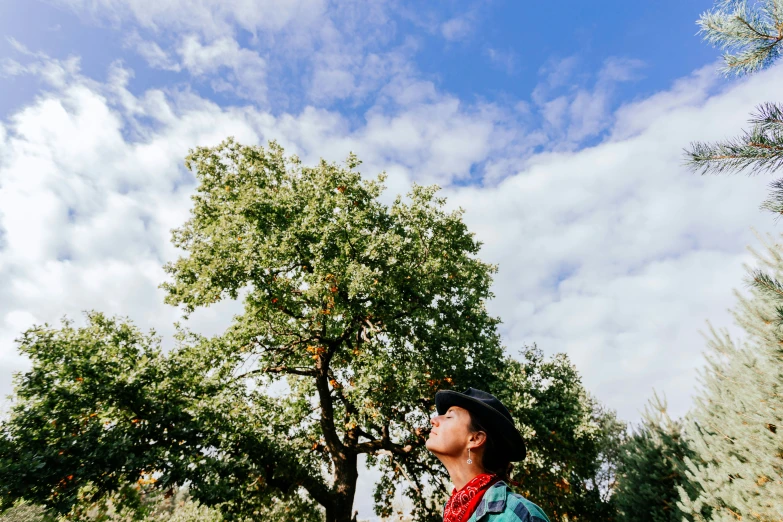 a boy wearing a hat is holding a cell phone in his hand