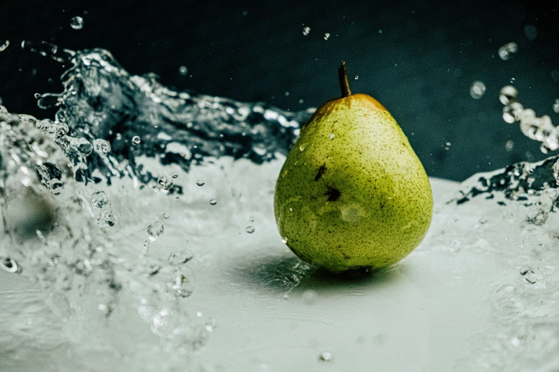 pear sitting in water with large bubbles on the surface