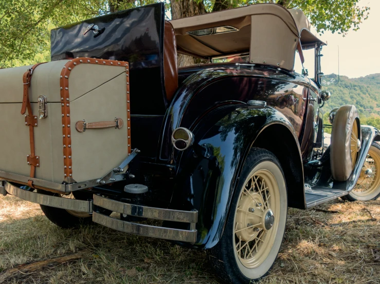 an old vintage truck with a trunk and trunk bag