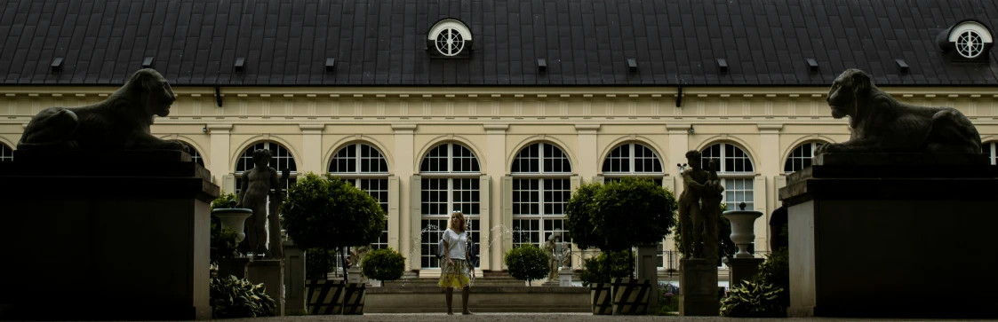 a couple of statues that are sitting on a building