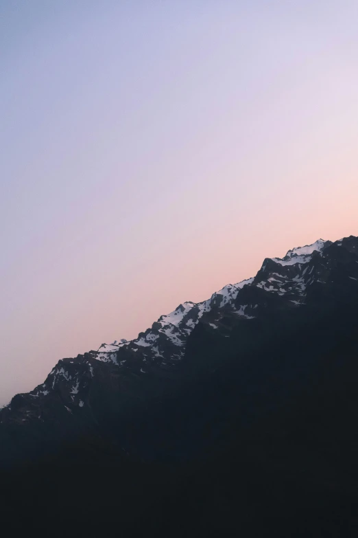 a skier is skiing through the air at dusk