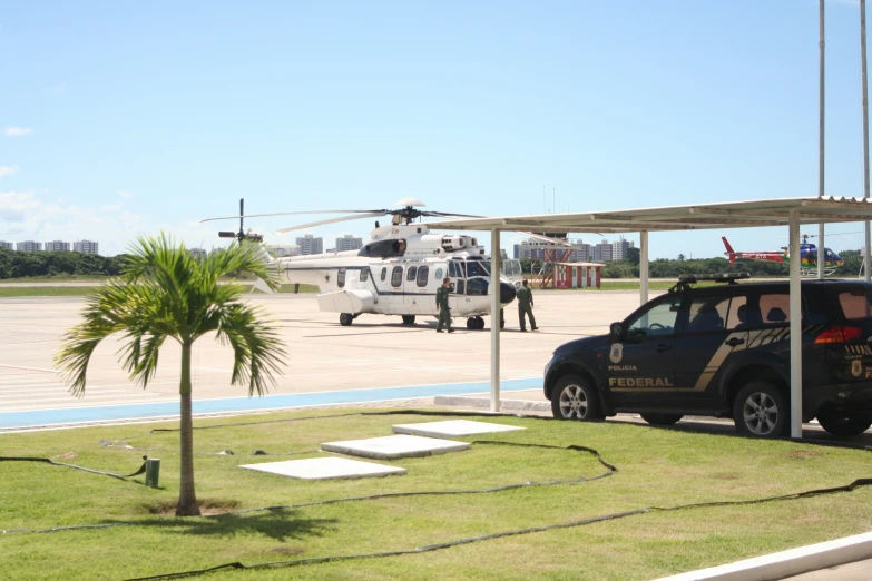 two military personnel getting off a helicopter to go for the military