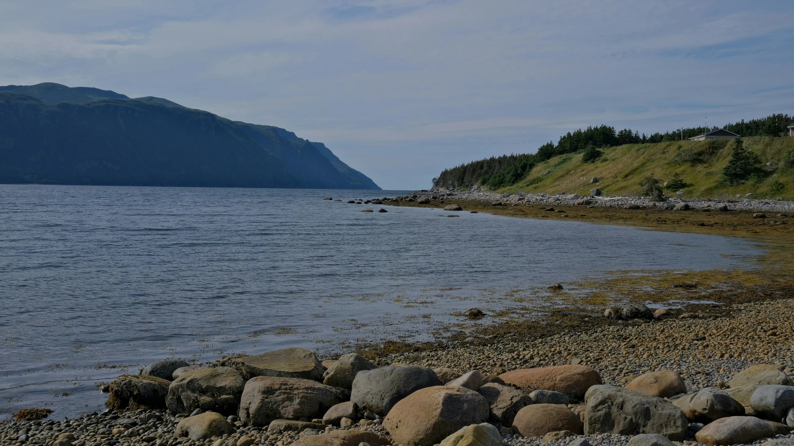 the large mountains near a water hole are close to the ocean