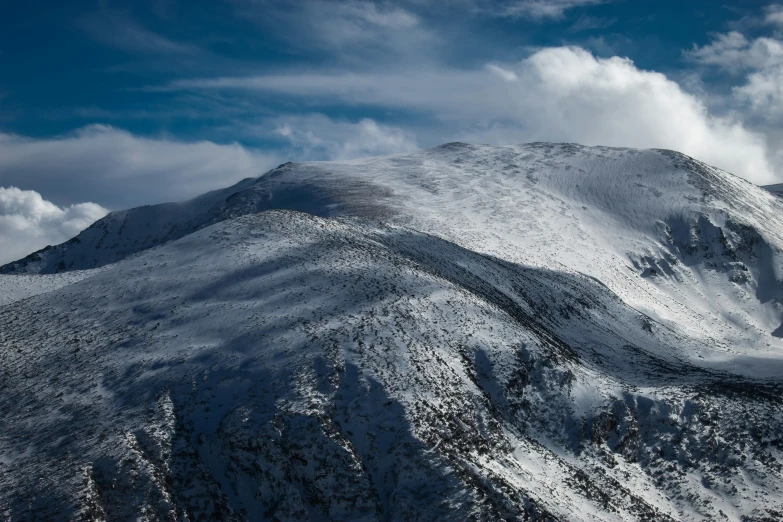 some snow covered mountains under a blue sky