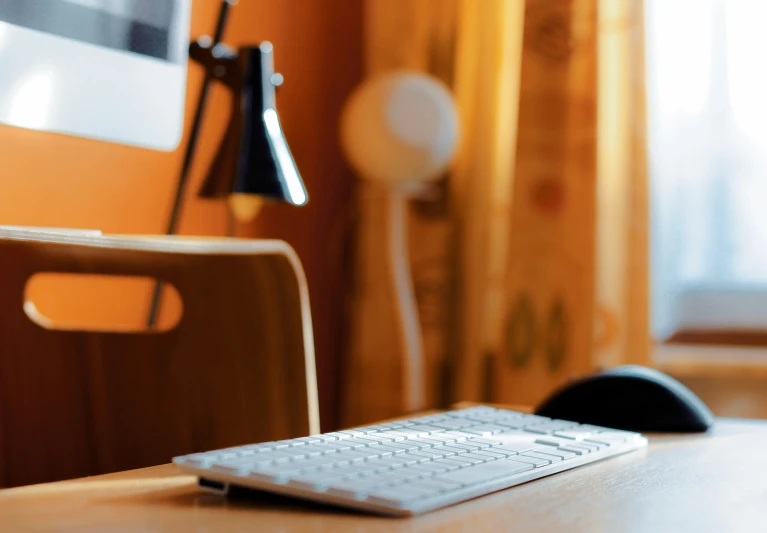 the keyboard sits on the table in front of the monitor