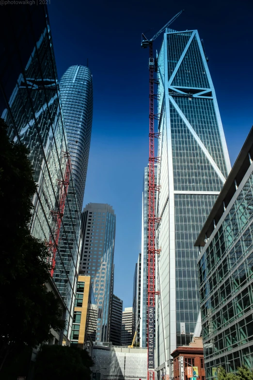 a crane on top of a tower near some buildings