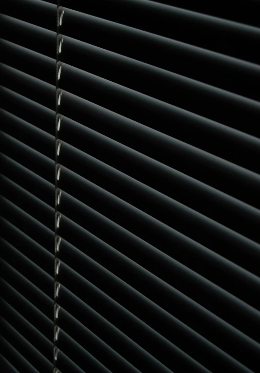 closeup of dark, blinded blind from a closed window