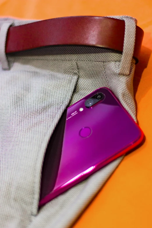 the purple phone is laying inside the bag