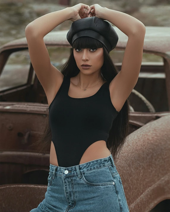a young woman wearing a black shirt and denim jean shorts