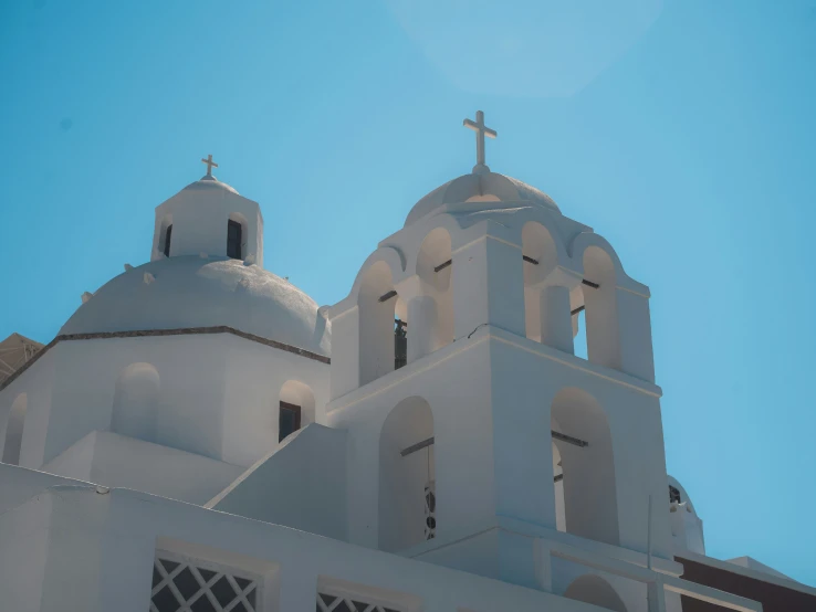 a church with two white clocks on the tower