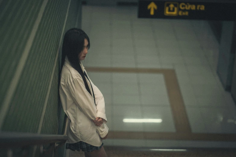 woman in coat waiting at subway station for subway train