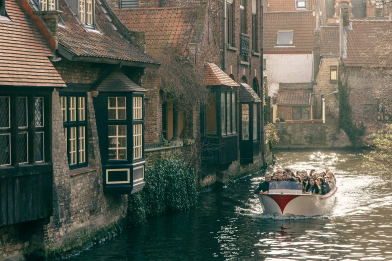 a white boat traveling through a river next to buildings