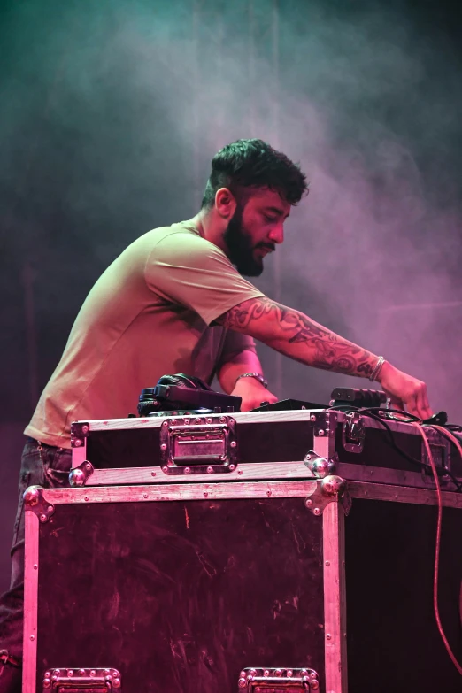 a dj mixing on top of a suitcase