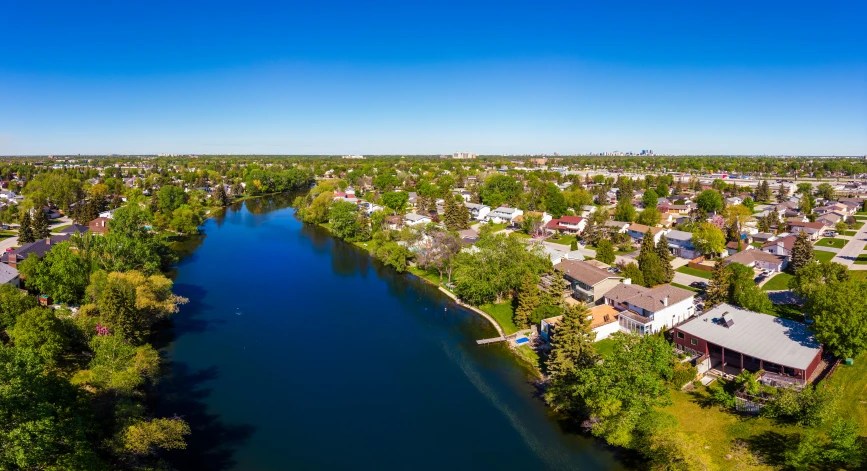 an aerial po of a body of water in front of houses