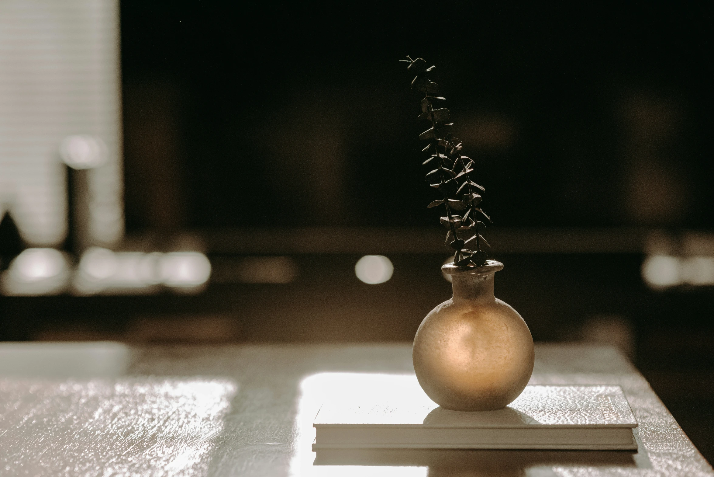 a small glass vase sitting on top of a wooden table