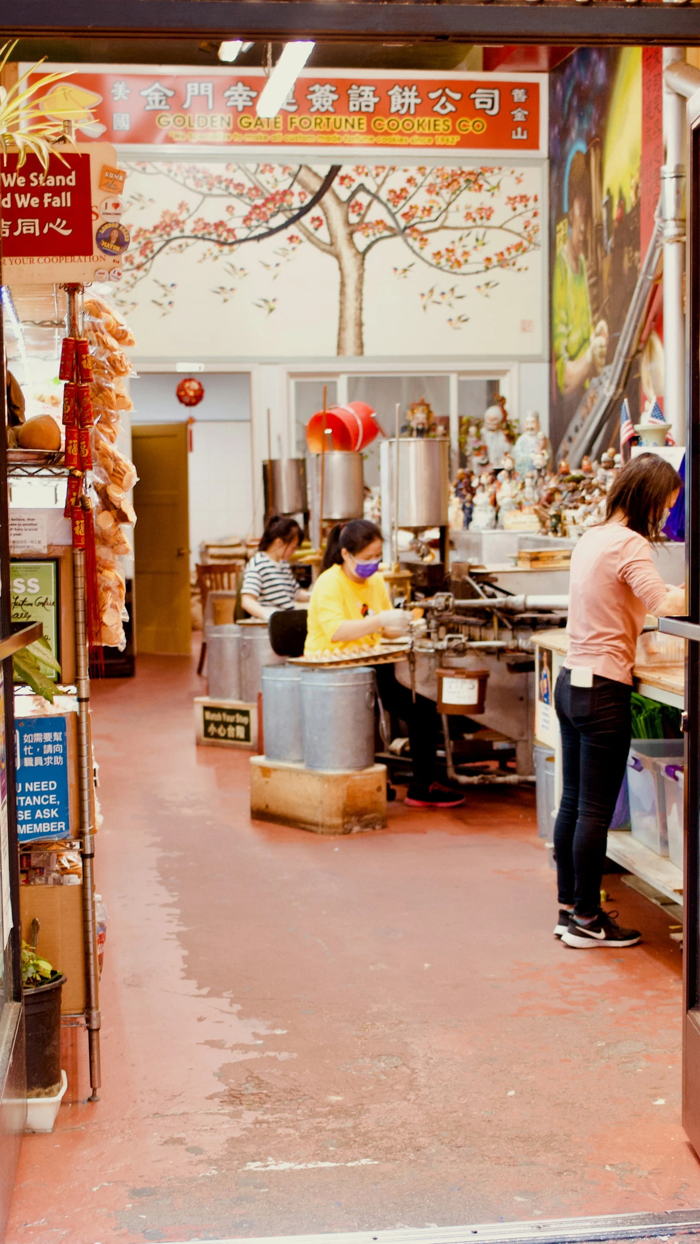 some women standing in a room and eating soing