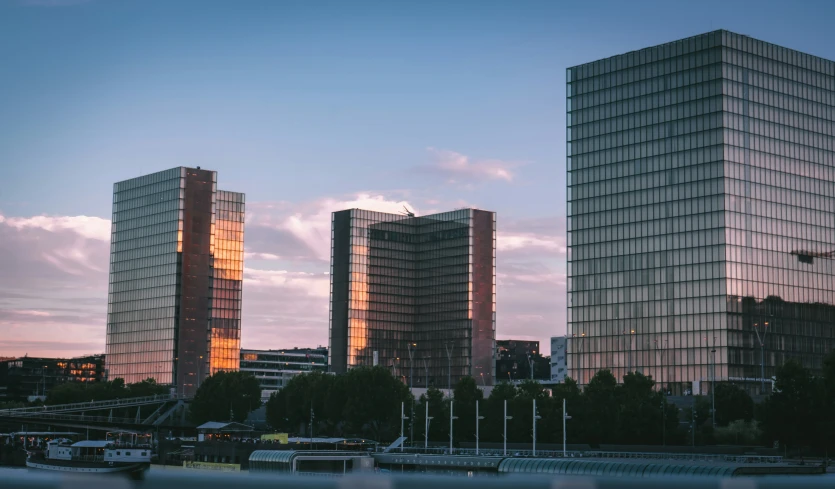 two office buildings beside a body of water