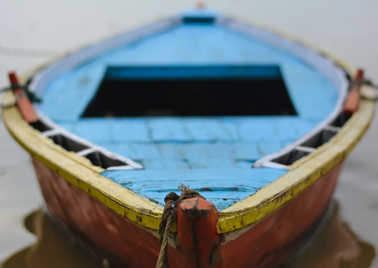 a small wooden boat sitting on the beach