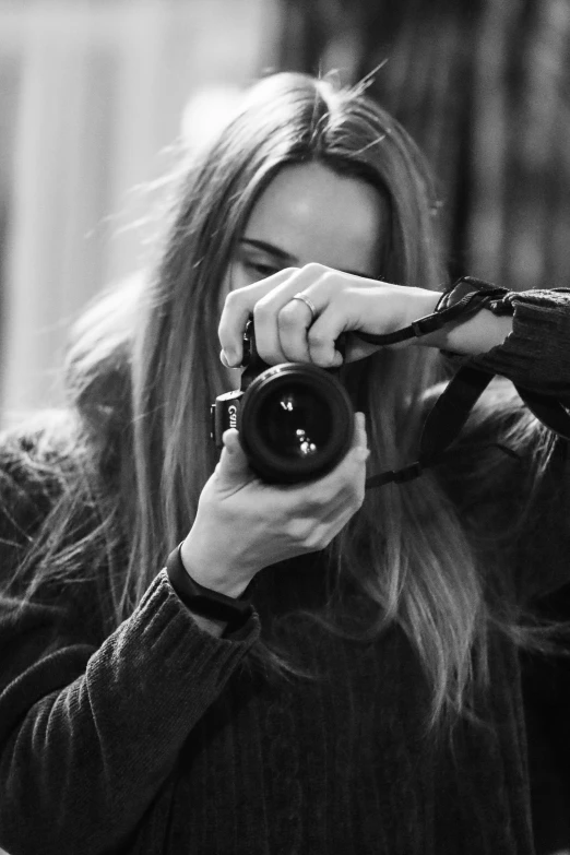 a woman is taking a po while she's holding her camera