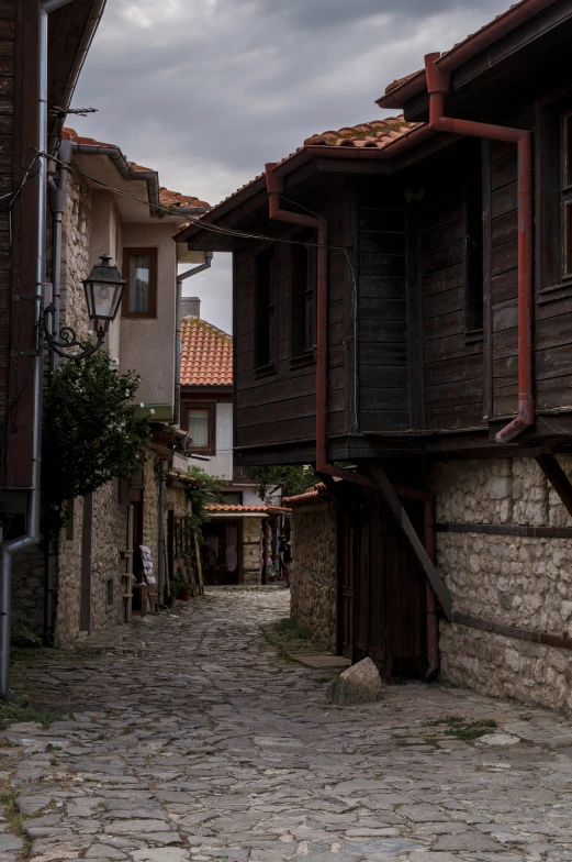 an alley way with cobblestones leads into several buildings