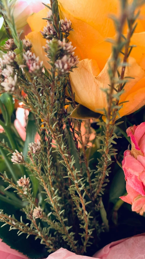 the bouquet is decorated with flowers and grasses