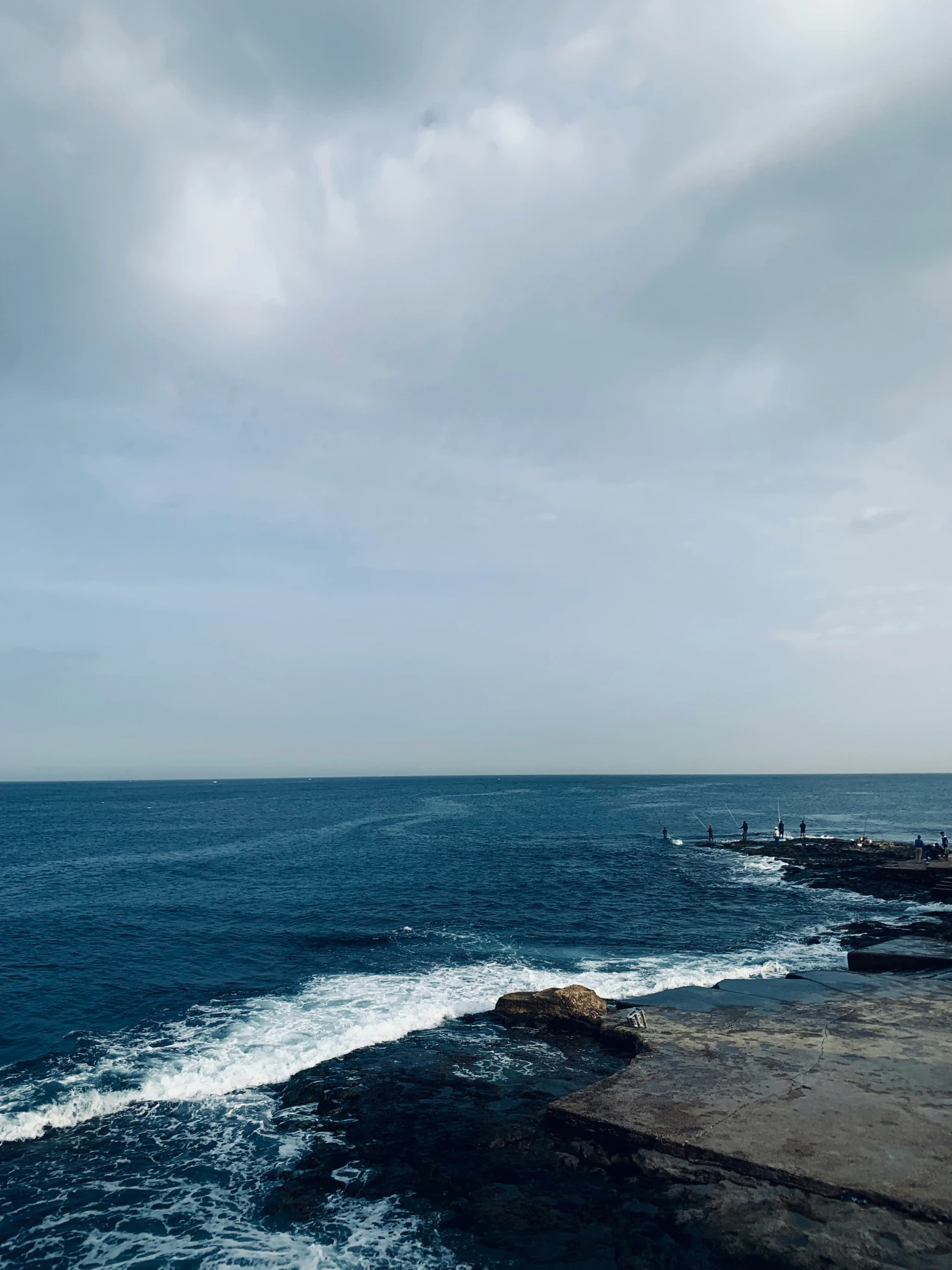 a large body of water with waves coming in to shore