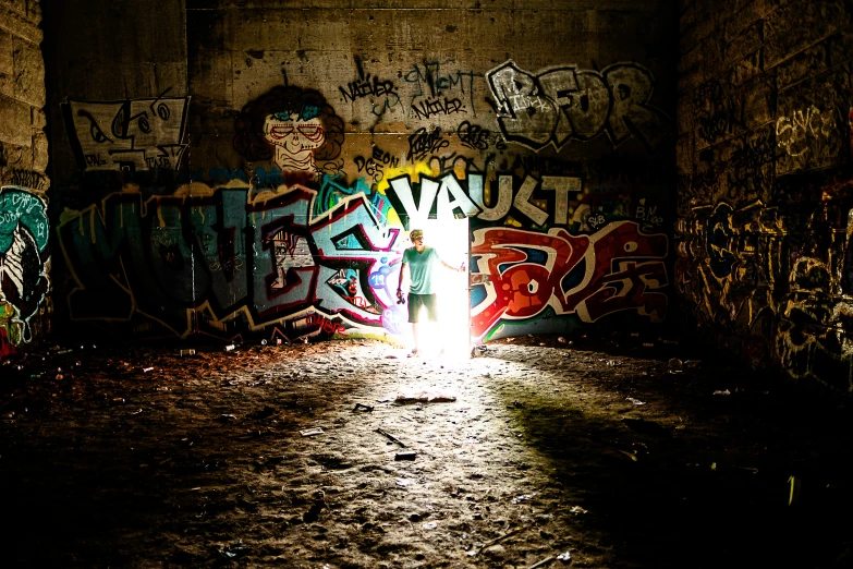 an alley with graffiti and light shining through
