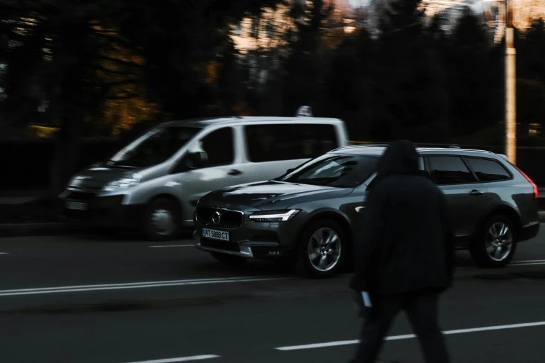 the car is driving on the street next to the other cars