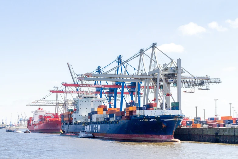 the large cargo ship is sitting at the dock