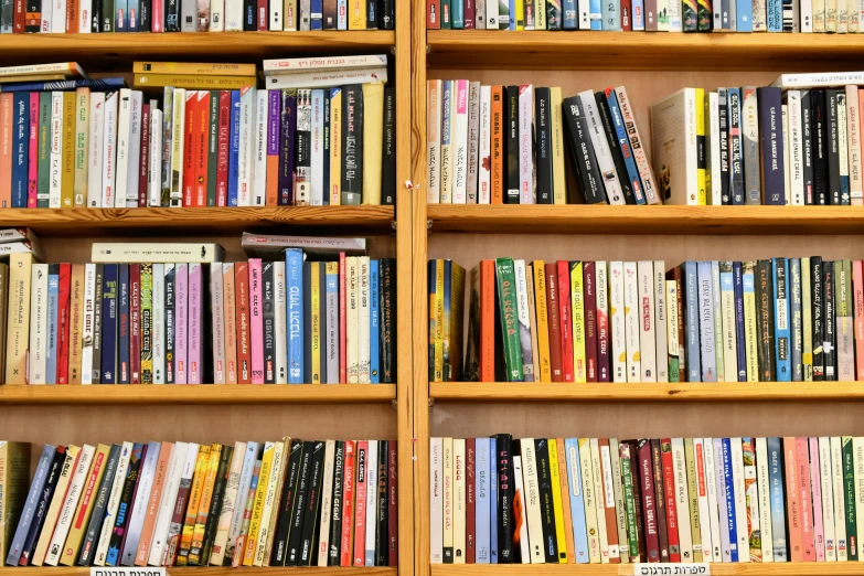 an array of books on the wooden shelf