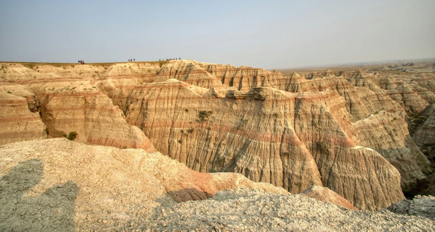 a group of people riding horses down the side of a cliff