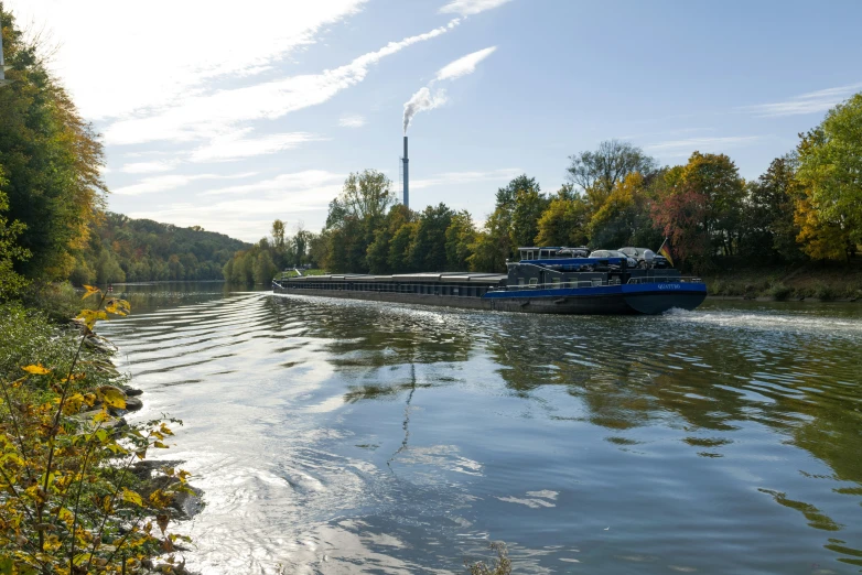 a blue boat sailing down the river