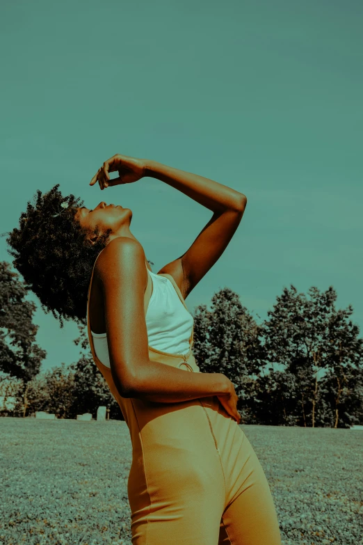 the woman is standing alone on a field