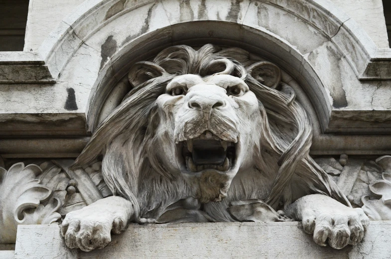 a very artistic lion sculpture is next to a door