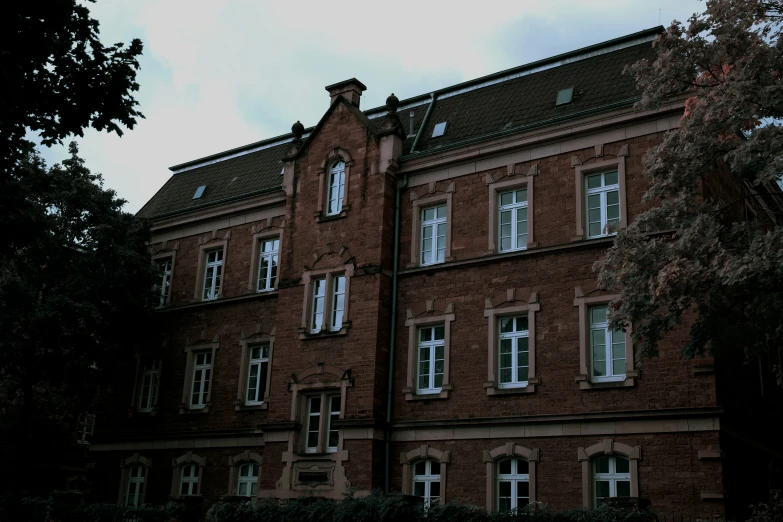 a tall red brick building with a clock on the front