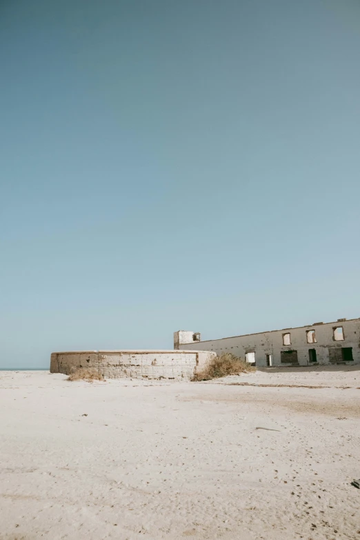 an old, run down building near the beach