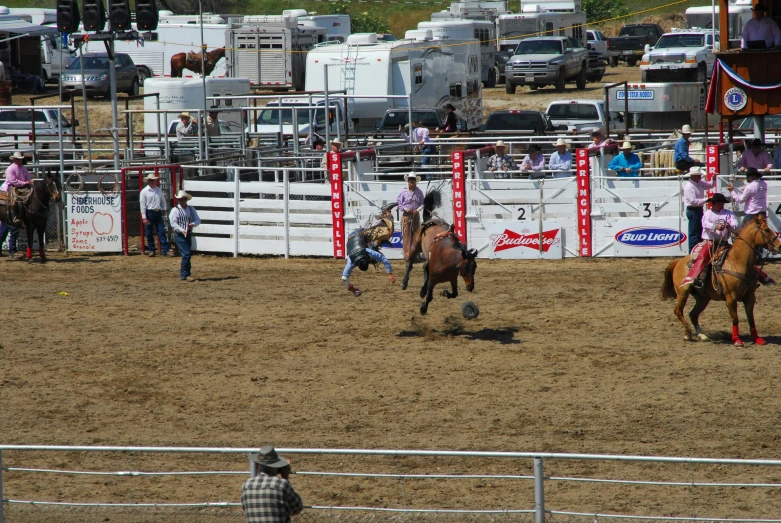 some men are riding horses and a couple of guys are chasing them