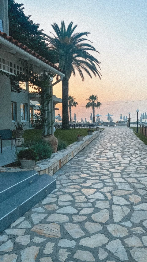 a long and narrow stone road near some houses