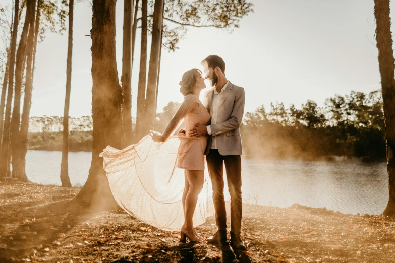 a man and a woman holding an umbrella in front of water