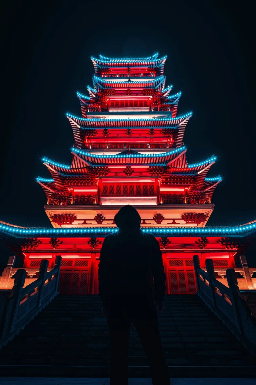 a dark picture of a person looking up at the building