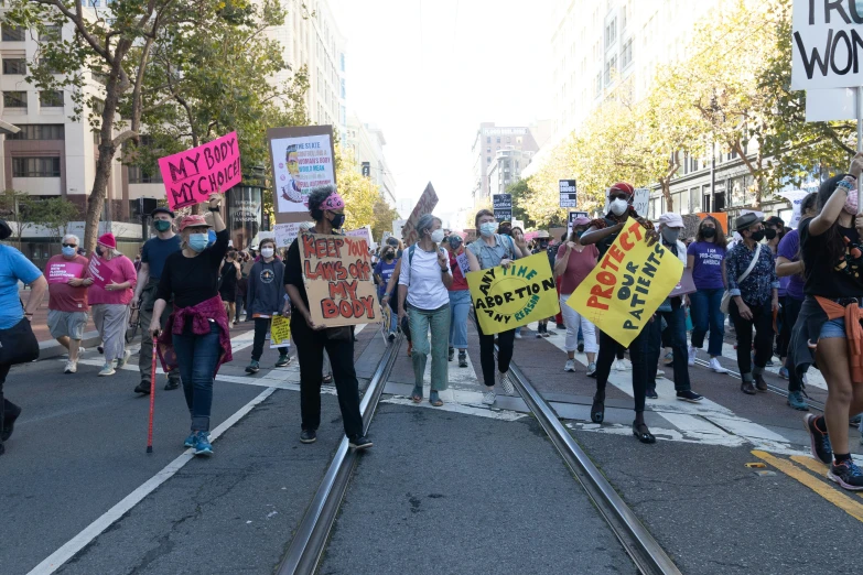 protestors marching in a protest on railway tracks