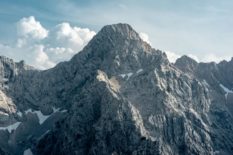 the top of a mountain with a plane flying by