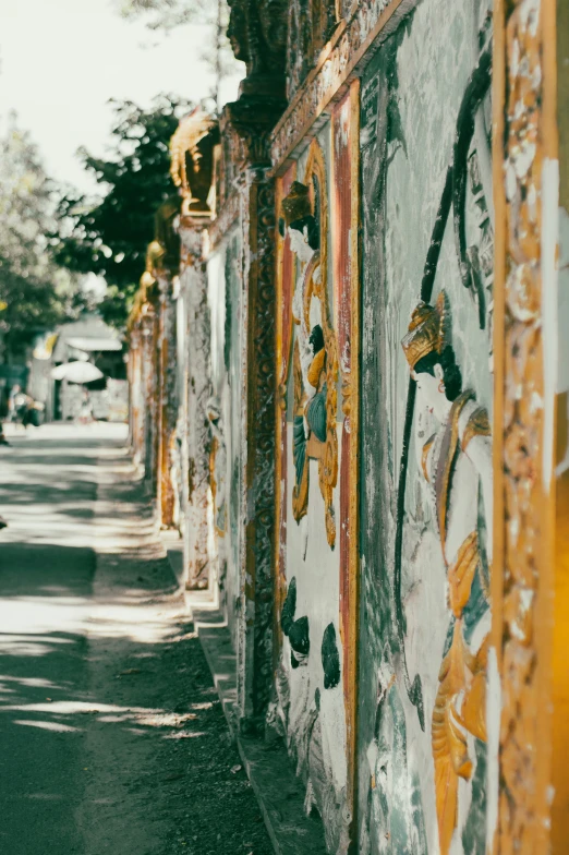 a long line of colorful painted wall with a person