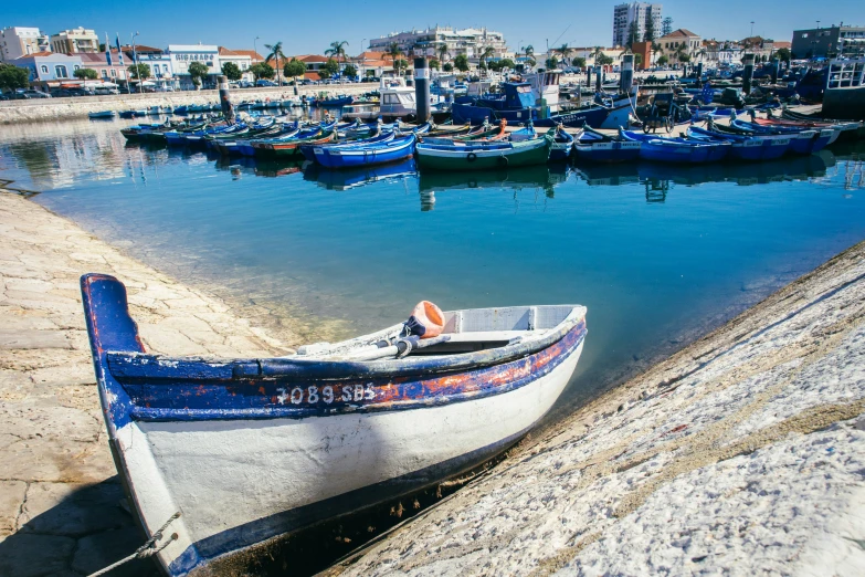 small fishing boats docked at a waterfront city