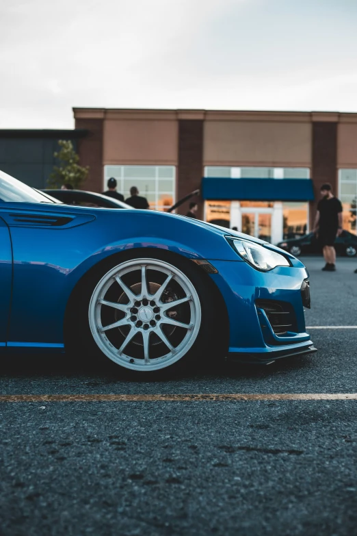 a car parked in a parking lot near a building