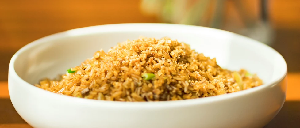 food items in a white bowl on wooden table