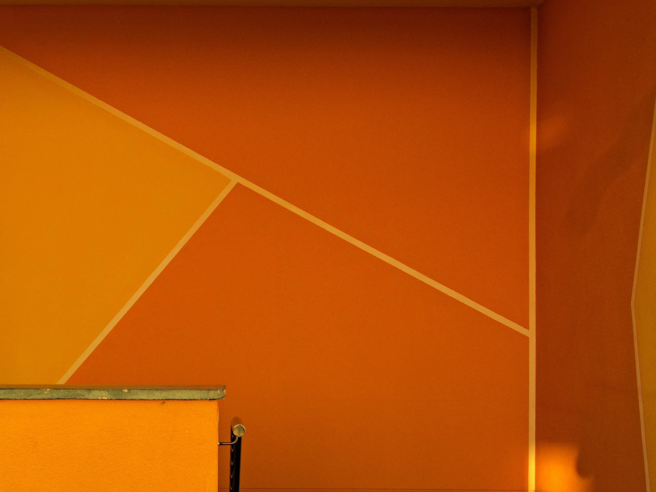 a yellow suitcase sitting by a wall in a room